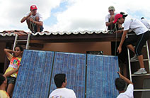 Brazilian youth install solar panels on top of a local computer center