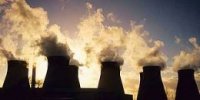 Cooling towers letting out steam and smoke at a coal-fired power station near Pontefract in Yorkshire, UK.